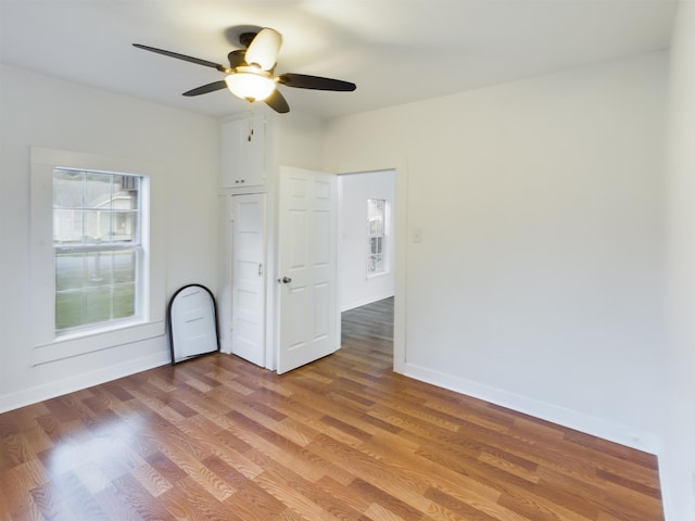 spare room with wood-type flooring and ceiling fan