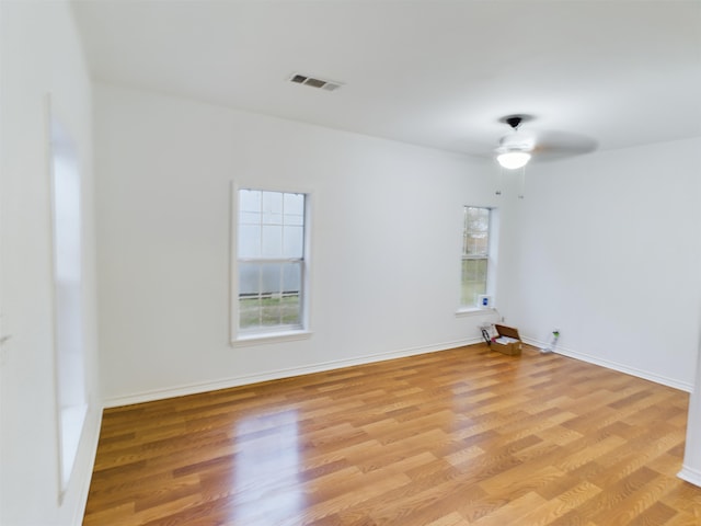 unfurnished room featuring ceiling fan, a healthy amount of sunlight, and light wood-type flooring