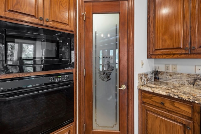 27076 Interstate 10, Winnie, TX 77665 - kitchen featuring black appliances, brown cabinetry, and light stone counters