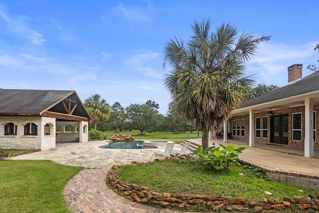 27076 Interstate 10, Winnie, TX 77665 - view of green lawn featuring an in-ground hot tub, a patio area, ceiling fan, and an outdoor pool