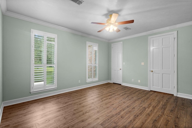 27076 Interstate 10, Winnie, TX 77665 - unfurnished bedroom featuring dark wood finished floors, ornamental molding, baseboards, and ceiling fan