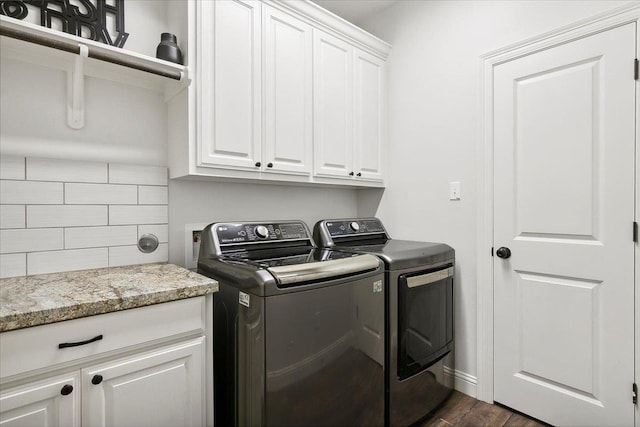 laundry area with cabinet space, dark wood-type flooring, and washer and clothes dryer