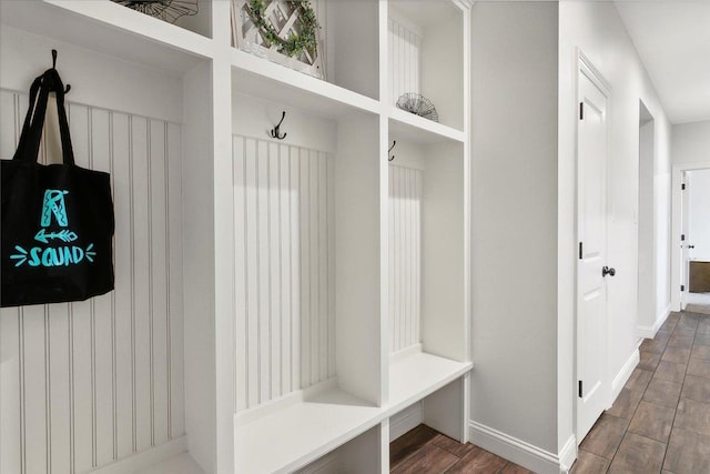 mudroom with baseboards and wood finished floors