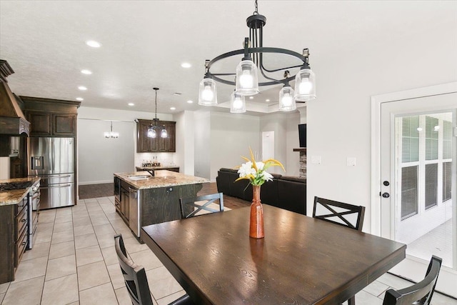 dining space featuring recessed lighting, an inviting chandelier, and light tile patterned flooring