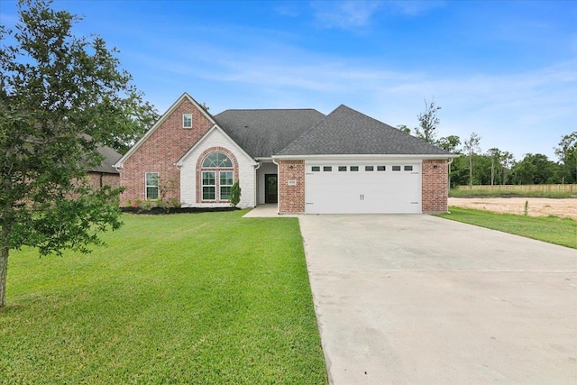 view of front facade with concrete driveway, an attached garage, brick siding, and a front lawn