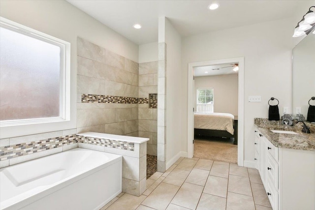 ensuite bathroom with a garden tub, a walk in shower, connected bathroom, tile patterned flooring, and vanity