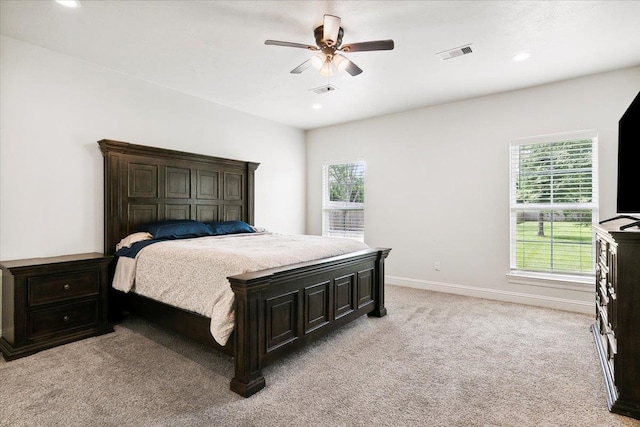 bedroom featuring visible vents, recessed lighting, baseboards, light colored carpet, and ceiling fan