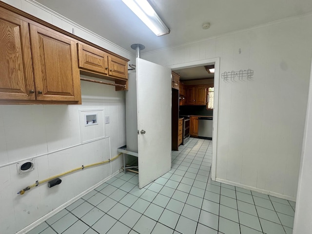 laundry room with cabinets, washer hookup, light tile patterned floors, and crown molding