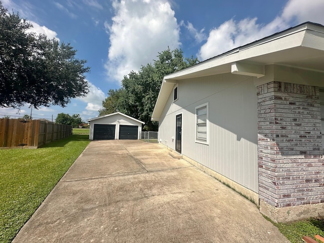 view of home's exterior featuring an outbuilding, a yard, and a garage