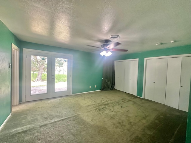 unfurnished bedroom featuring ceiling fan, french doors, light colored carpet, and a textured ceiling