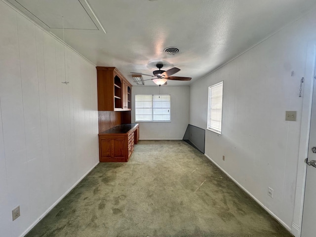 interior space featuring light carpet and ceiling fan