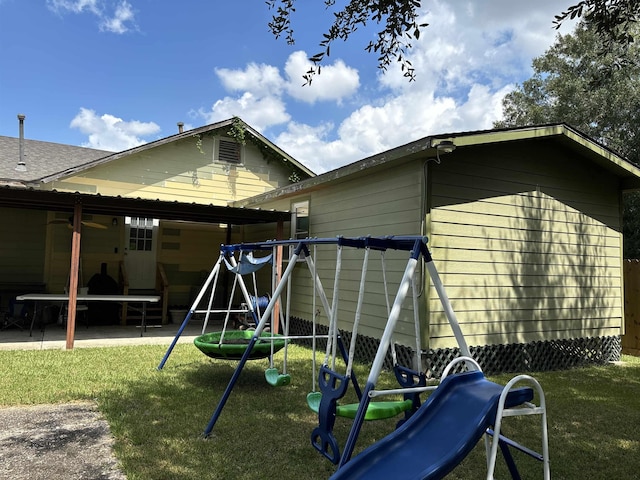 view of jungle gym featuring a lawn