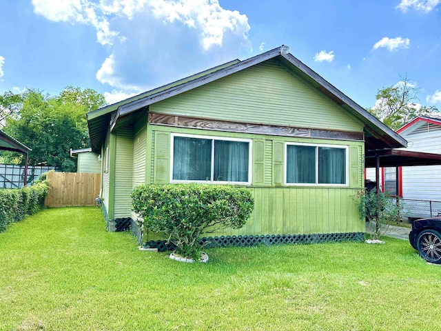 view of side of property with a lawn