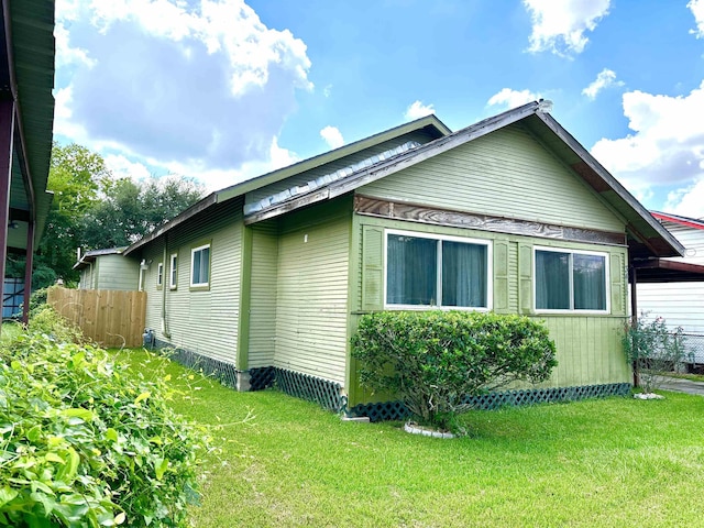 view of side of home featuring a lawn