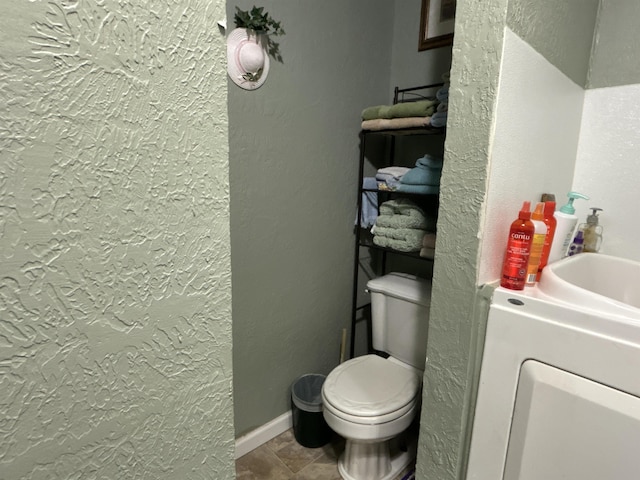 bathroom featuring tile patterned floors and toilet