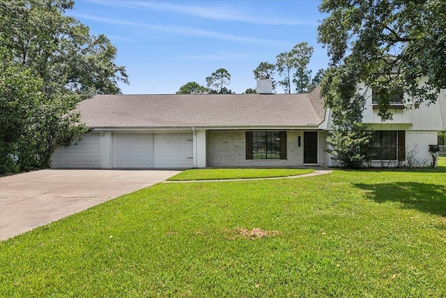 view of front of house featuring a garage and a front lawn