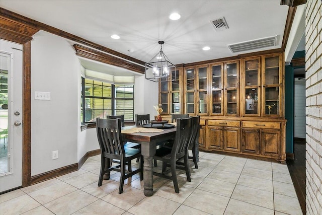 tiled dining area featuring a chandelier