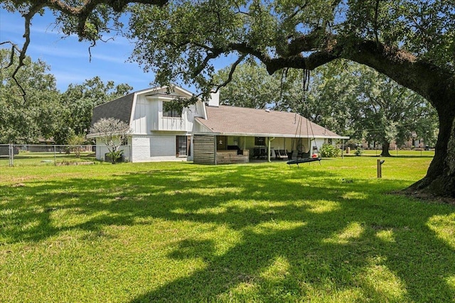 back of property featuring a lawn