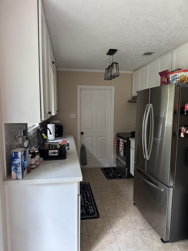 9325 Bamboo Ln, Beaumont, TX 77708 - kitchen featuring appliances with stainless steel finishes, white cabinets, light countertops, light tile patterned floors, and crown molding