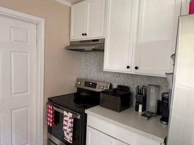 9325 Bamboo Ln, Beaumont, TX 77708 - kitchen featuring stainless steel range with electric cooktop, under cabinet range hood, backsplash, and white cabinetry