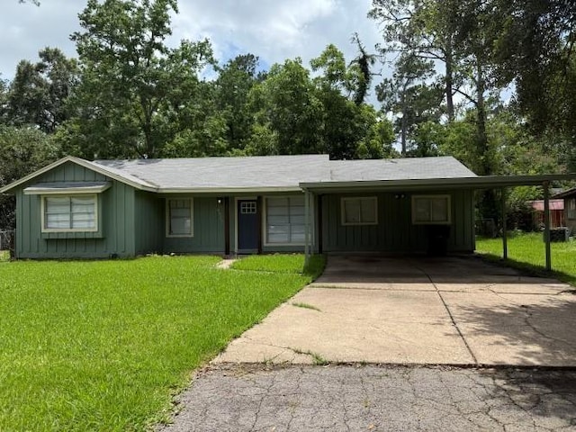 9325 Bamboo Ln, Beaumont, TX 77708 - ranch-style home with board and batten siding, driveway, and a front lawn