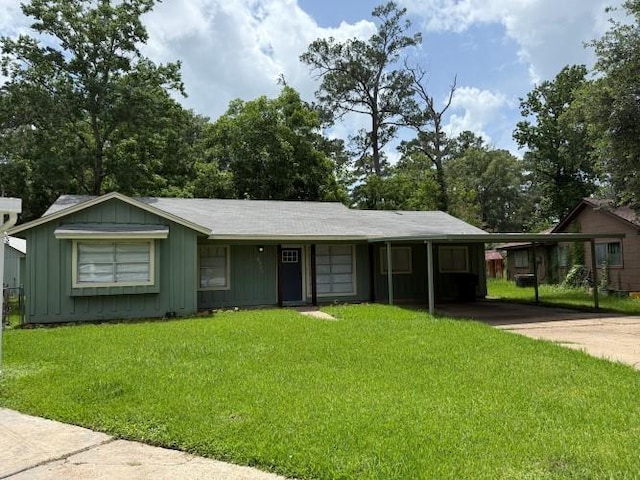 9325 Bamboo Ln, Beaumont, TX 77708 - view of front of property featuring a front yard, driveway, board and batten siding, and an attached carport