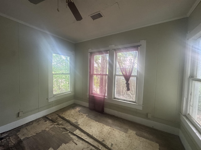 1598 Euclid St, Beaumont, TX 77705 - unfurnished room with ornamental molding, healthy amount of natural light, a decorative wall, a ceiling fan, and baseboards
