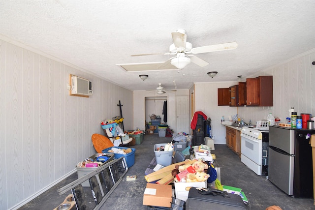 interior space with a wall mounted AC, ceiling fan, and a textured ceiling