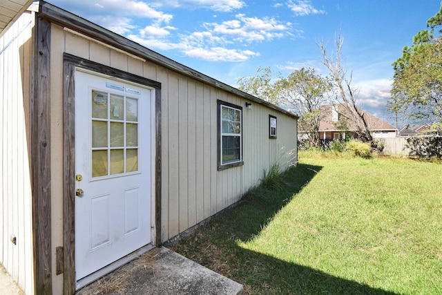 view of side of property with an outbuilding and a yard