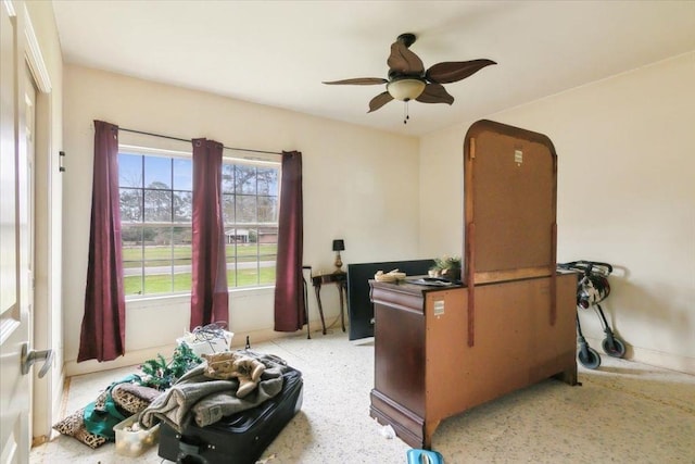 office with a wealth of natural light and ceiling fan