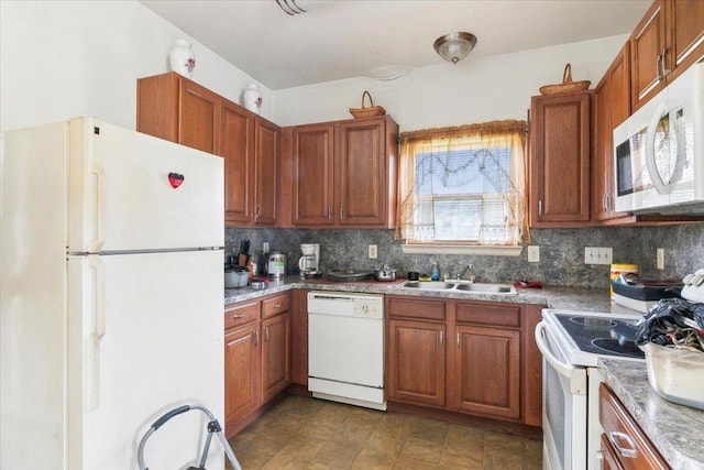 kitchen with tasteful backsplash, sink, and white appliances