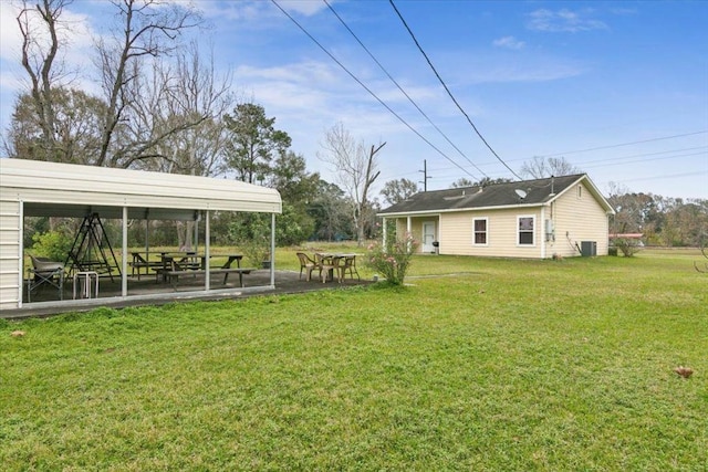 view of yard with a patio area and central air condition unit