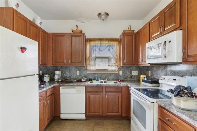 kitchen with tasteful backsplash, a healthy amount of sunlight, sink, and white appliances