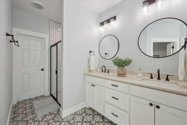 560 Lyndale St, Vidor, TX 77662 - bathroom featuring a tile shower, baseboards, double vanity, and tile patterned floors
