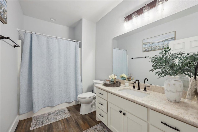 560 Lyndale St, Vidor, TX 77662 - full bathroom with wood finished floors, toilet, vanity, and shower / tub combo