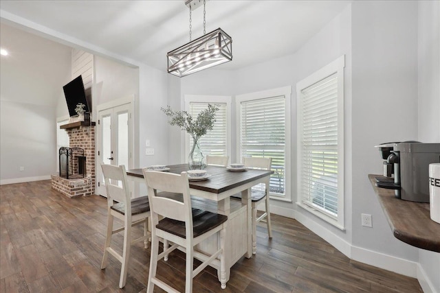 560 Lyndale St, Vidor, TX 77662 - dining space featuring dark wood-type flooring, baseboards, and a brick fireplace