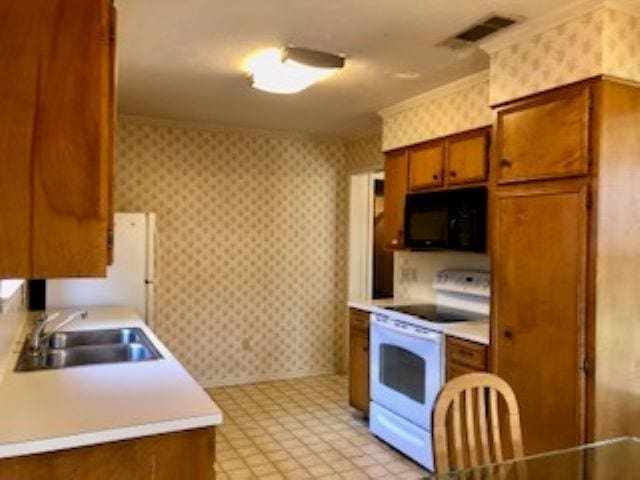 kitchen featuring white electric range oven and sink