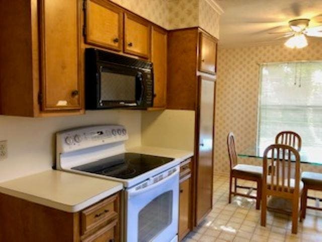 kitchen with white electric range oven and ceiling fan