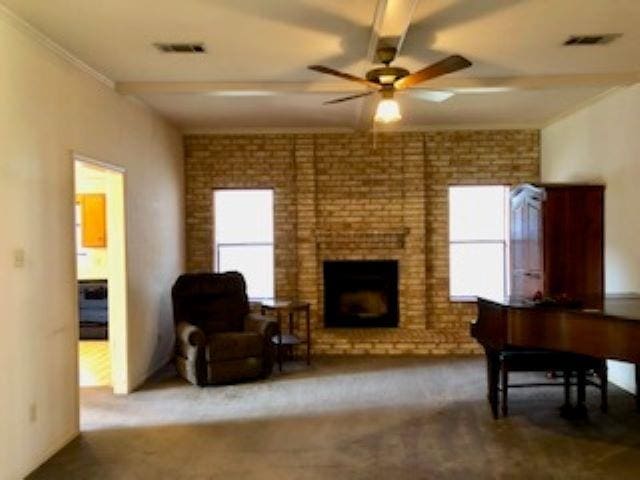 carpeted living room featuring a fireplace and ceiling fan