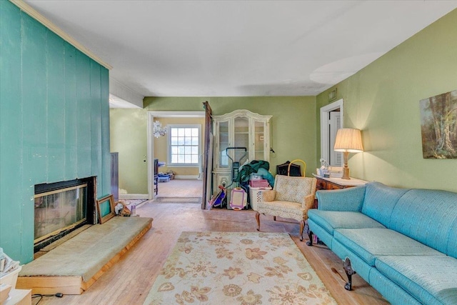 living room with a large fireplace and light hardwood / wood-style floors