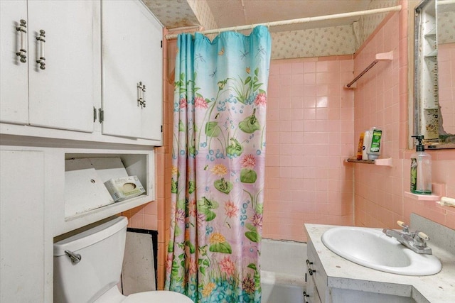 full bathroom featuring toilet, vanity, shower / tub combo with curtain, and tile walls