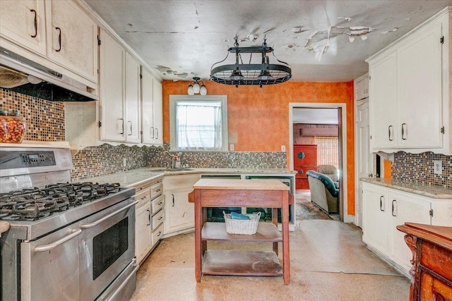 kitchen with white cabinets, decorative backsplash, stainless steel range with gas cooktop, and sink