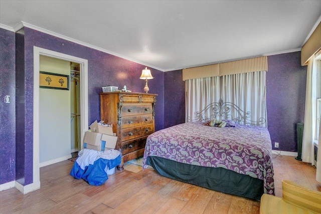 bedroom featuring wood-type flooring, ornamental molding, and radiator heating unit