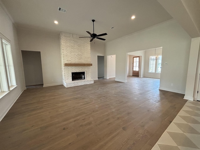6560 Brayfield Ln, Beaumont, TX 77706 - unfurnished living room with a ceiling fan, crown molding, a brick fireplace, dark wood finished floors, and recessed lighting