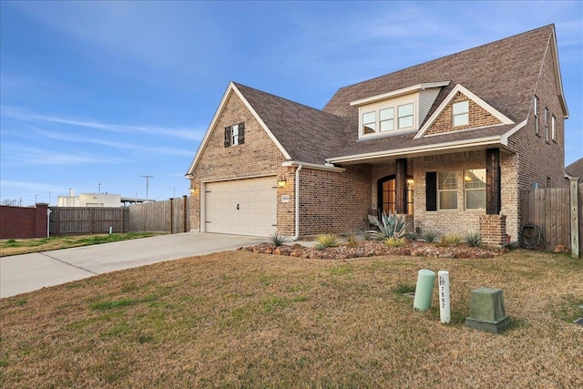 view of front of home with concrete driveway, a front lawn, fence, and brick siding