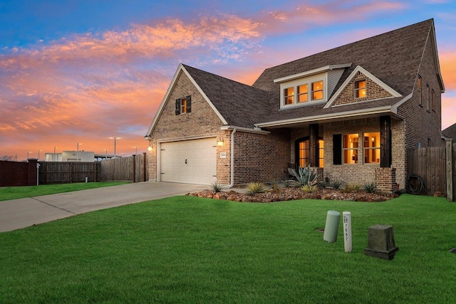 view of front facade featuring brick siding, concrete driveway, a lawn, fence, and a garage