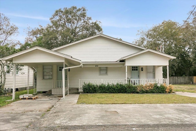 view of front of home with a front yard and a carport