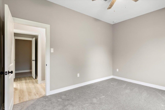 carpeted spare room with ceiling fan