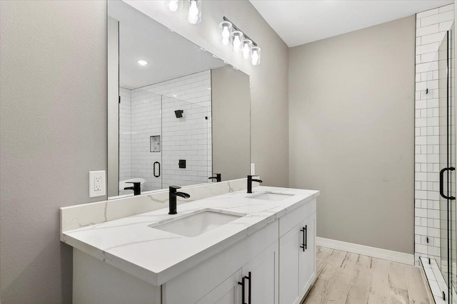 bathroom featuring hardwood / wood-style floors, vanity, and walk in shower