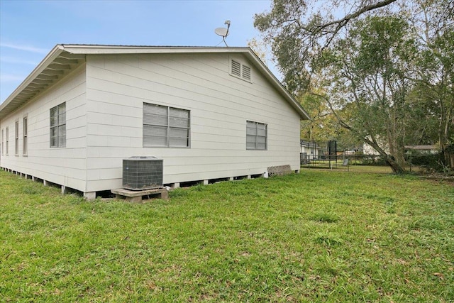 view of home's exterior with a lawn and cooling unit